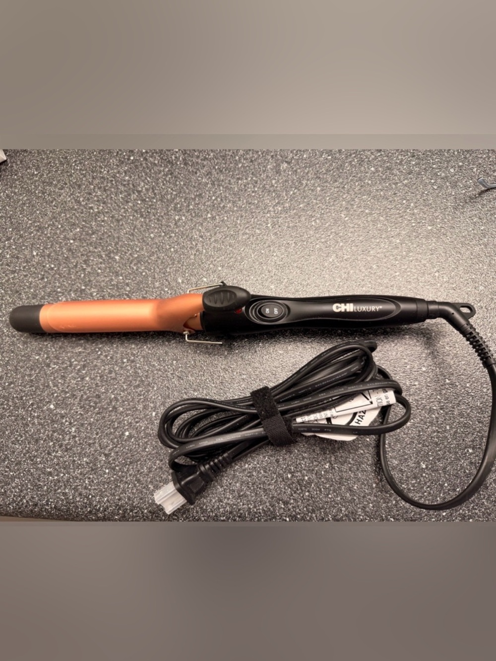 Ceramic curling iron by Chi with light scratches. Barely used!